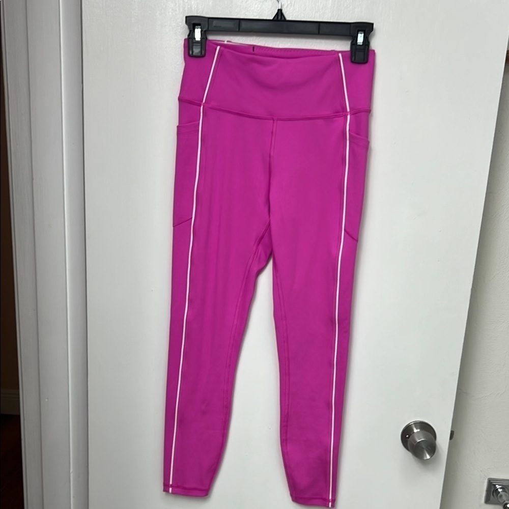 Victoria's Secret Essential Pocket Leggings in Berry Pink with white piping.